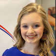 Chloe S - Youth Advisory Board. Teen girl with blonde hair wearing blue dress