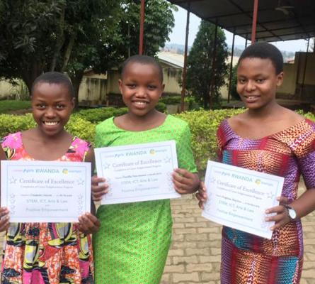Photo of three girls holding certificates of excellence