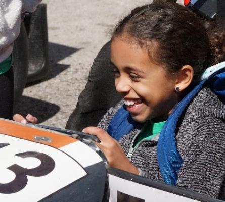 Girl smiling in a race car