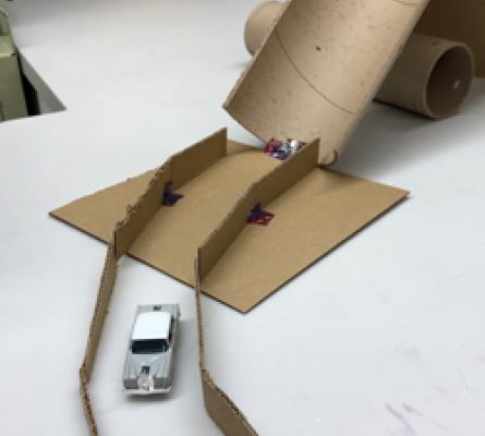 Matchbox car on a track made of cardboard
