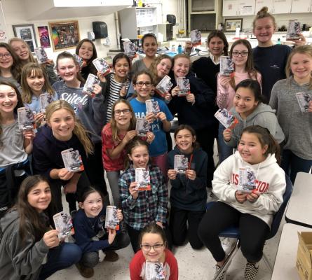 Group of 6th grade girls holding matchbox cars