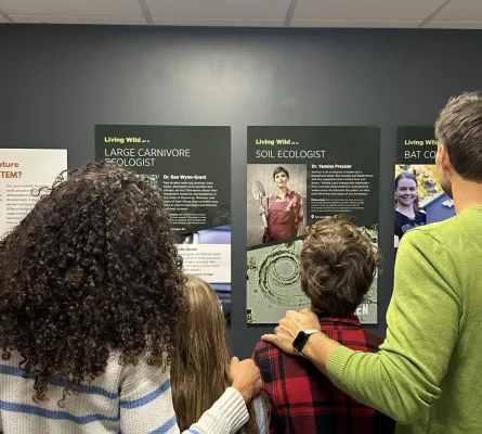 Family looking at IF/THEN Posters