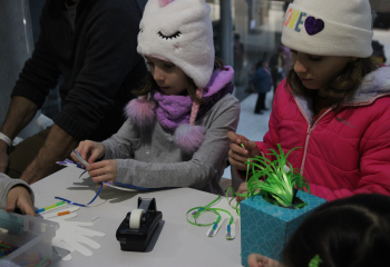 two girls looking at stem experiment