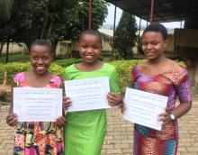 Photo of three girls holding certificates of excellence