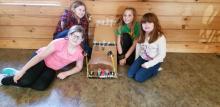 Four girls with a cardboard ramp