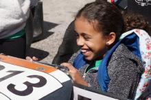 Girl smiling in a race car