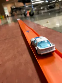 White matchbox car on an orange track
