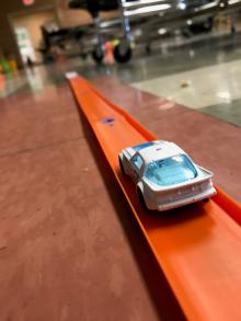 White matchbox car on an orange track