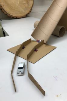 Matchbox car on a track made of cardboard