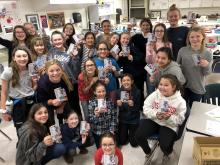 Group of 6th grade girls holding matchbox cars