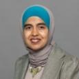Zahra Hazari - Woman wearing blue and gray head wrap and gray jacket