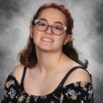 Mackenzie C - teenage girl with brown hair and classes wearing floral print top