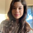 Renata L - teenage girl with long brown hair wearing plaid shirt