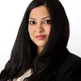 Parul Kalve - photo of woman with long, black hair wearing light colored top and black blazer