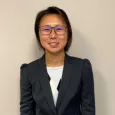 Ada Leung - Woman with dark hair and glasses wearing a blazer