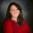 Kelli Shrewsberry - photo of woman with brown hair wearing red top and necklace