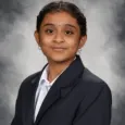 Vaishnavi Renduchintala - school photo of teen girl with dark hair wearing a blazer and white shirt