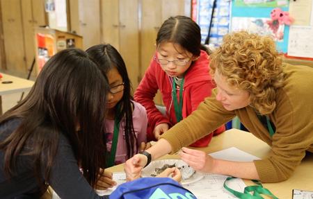 Girls investigating owl pellets