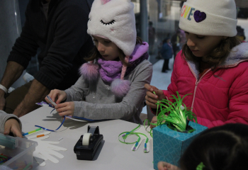 two girls at a science fair doing stem activities